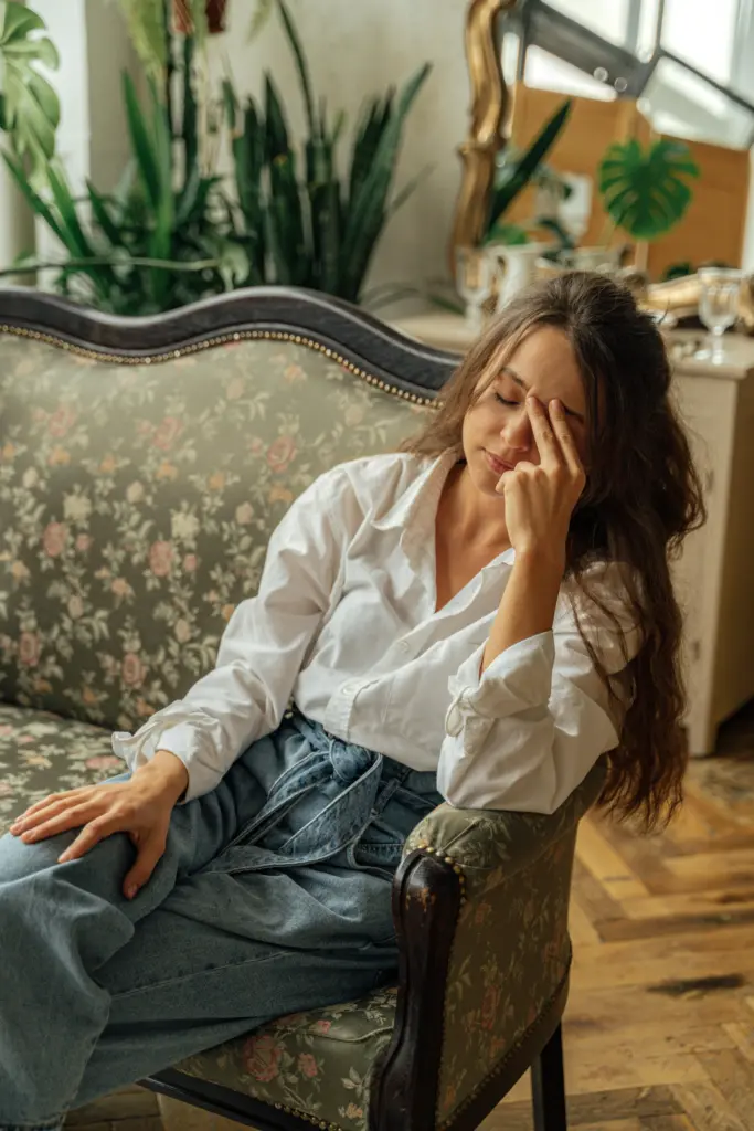 Women Stressed And Upset Sitting On A Couch With Eyes Closed