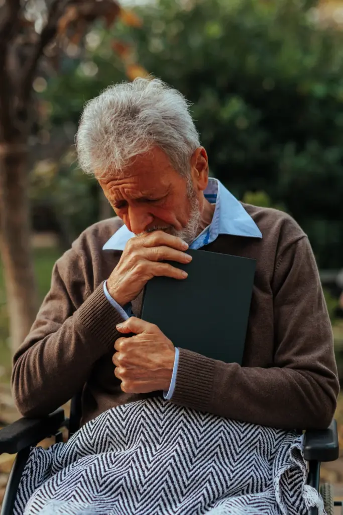 Man Clutching Book Sad